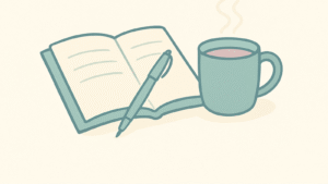 Open notebook with a pen draped across the middle of it and a steaming cup of coffee to the right of the notebook